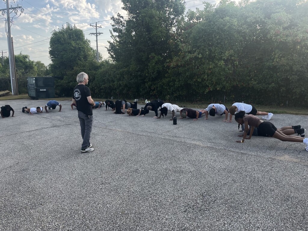 teachers instructing students to do pushups