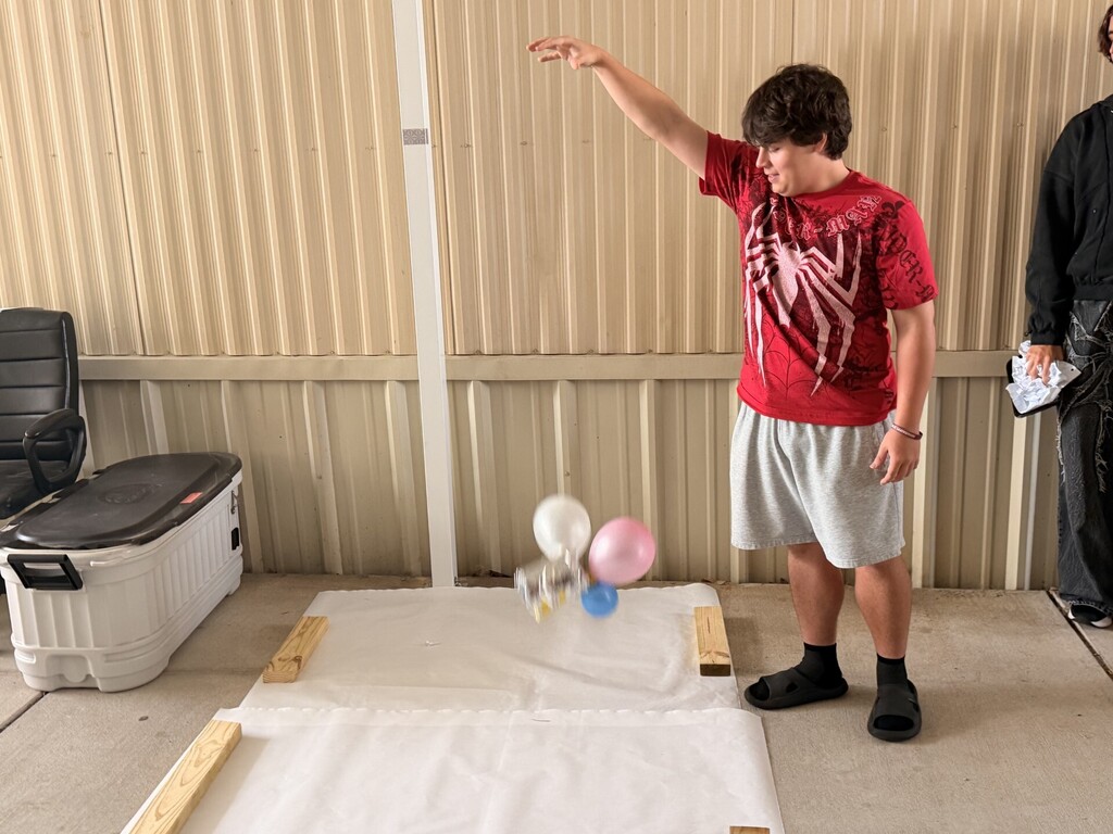 student dropping package with egg inside