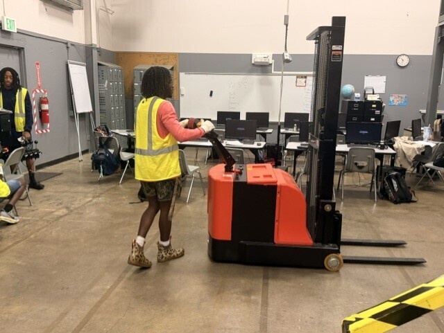student driving a forklift