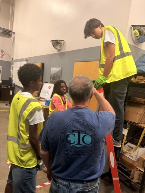 teacher instructing on ladder safety