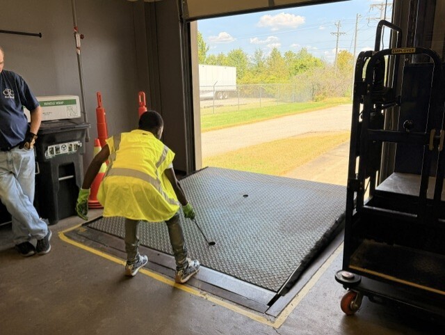 student raising dock leveler