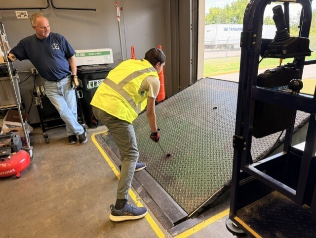 student raising dock leveler