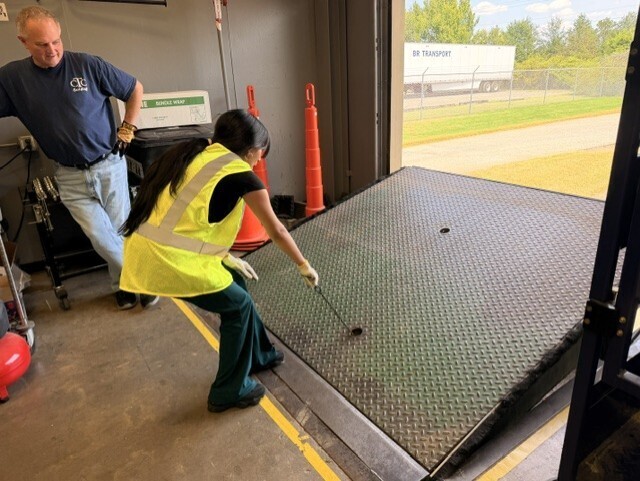 student raising dock leveler
