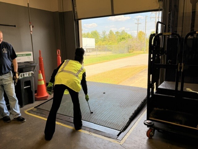 student raising dock leveler