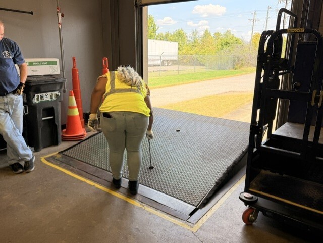 student raising dock leveler