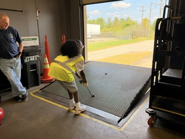 student raising dock leveler