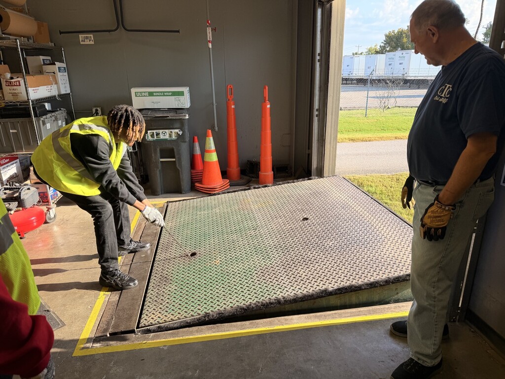 student raising dock leveler