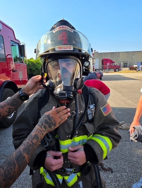 student trying on fire gear