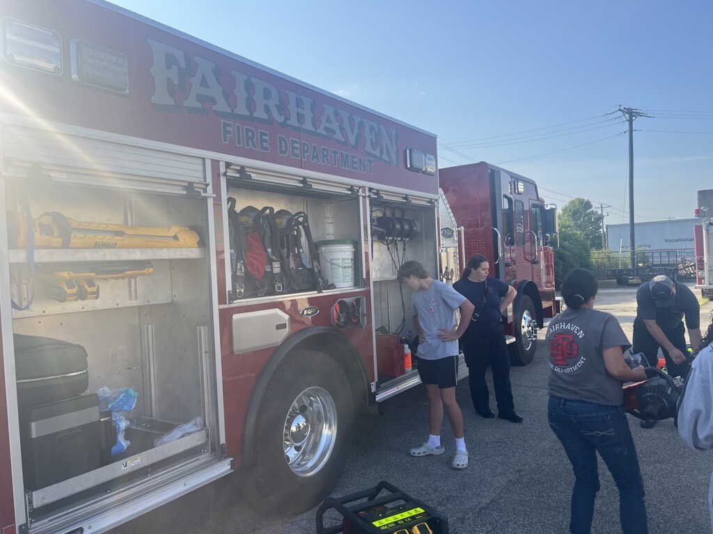 students gathered around firetruck