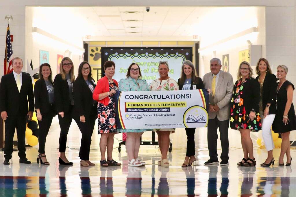 Admin posing with congratulations banner