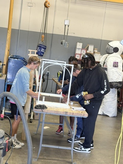 students putting together a desk