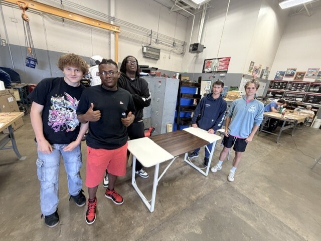 students standing by bench they put together