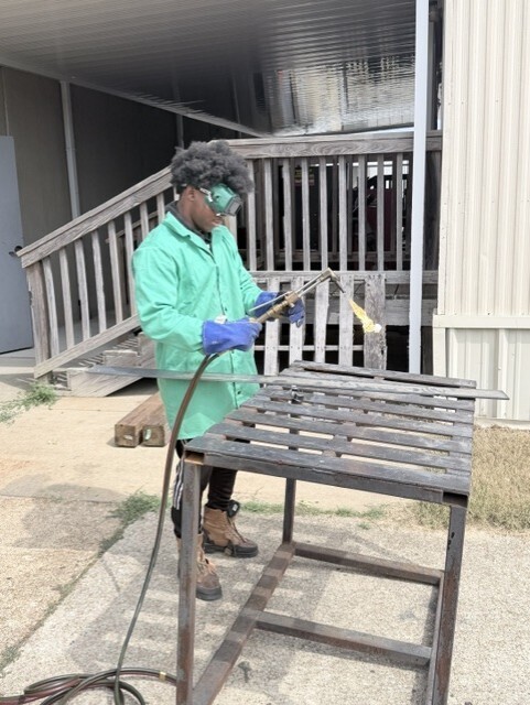 student using welding torch