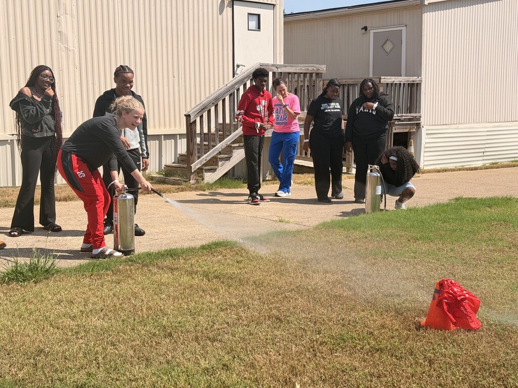 students practicing health care safety with fire extinguisher