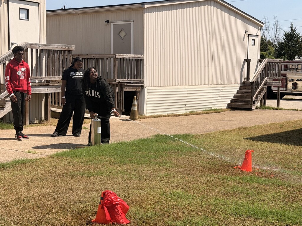 students practicing health care safety with fire extinguisher