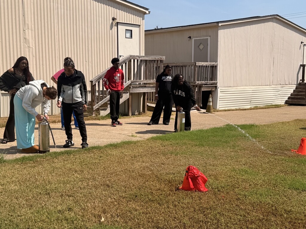 students practicing health care safety with fire extinguisher