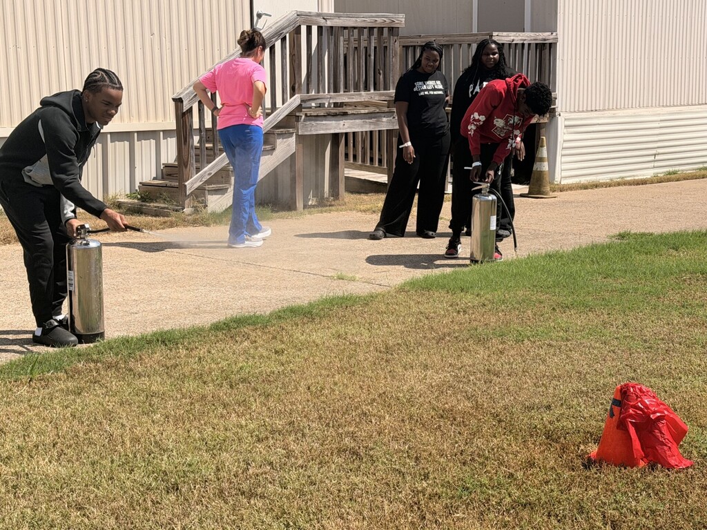 students practicing health care safety with fire extinguisher