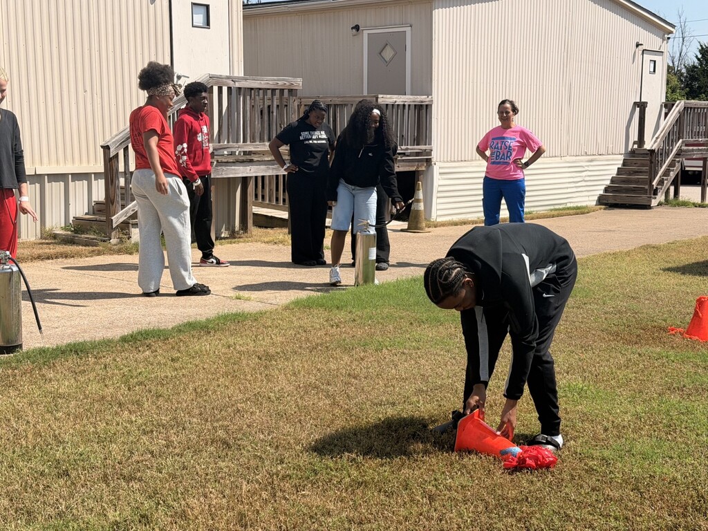 students practicing health care safety with fire extinguisher