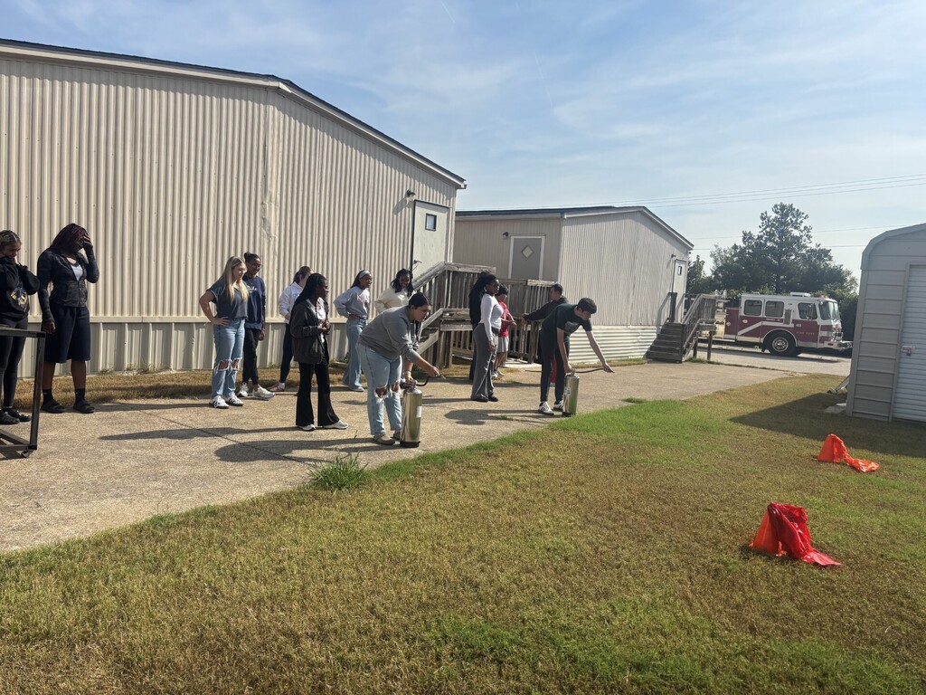 students practicing health care safety with fire extinguisher