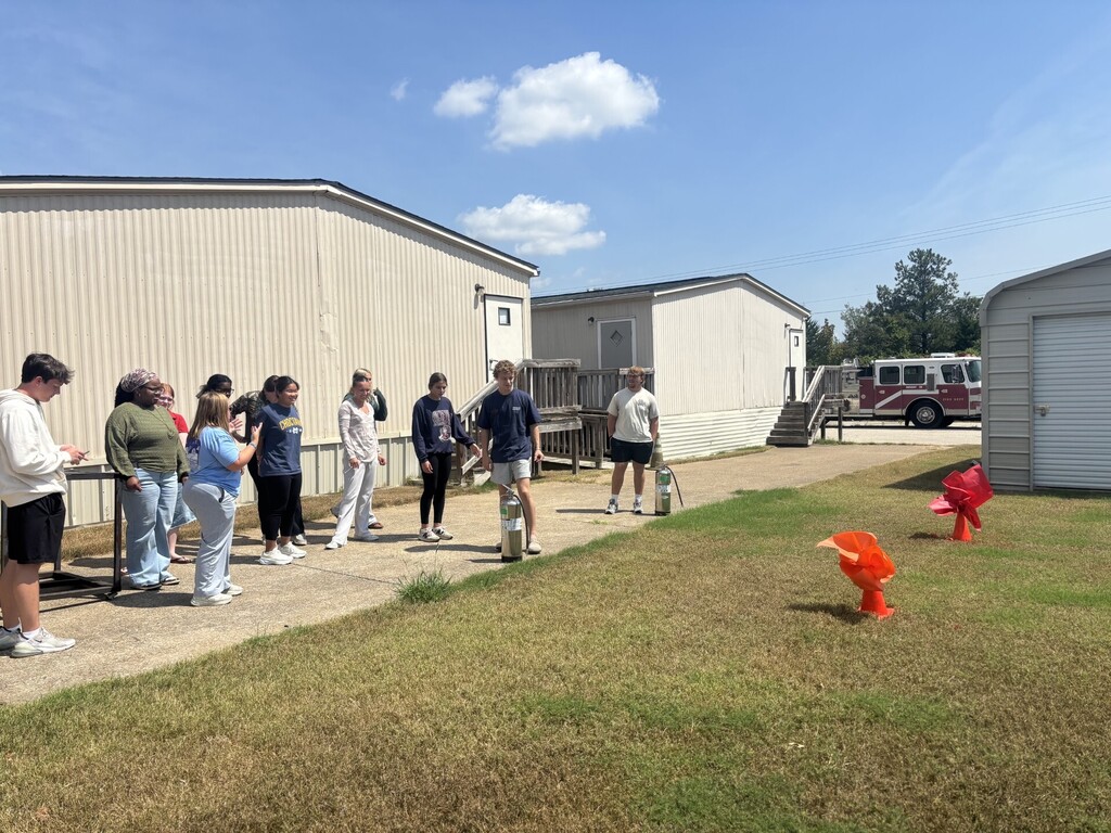 students practicing health care safety with fire extinguisher