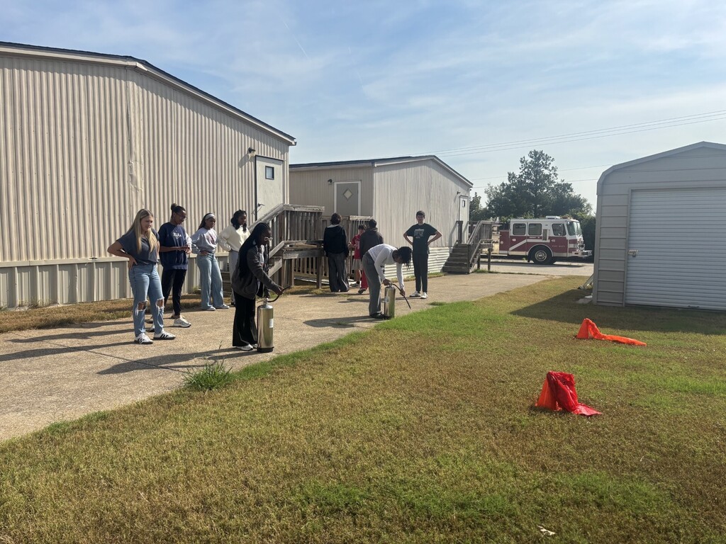 students practicing health care safety with fire extinguisher