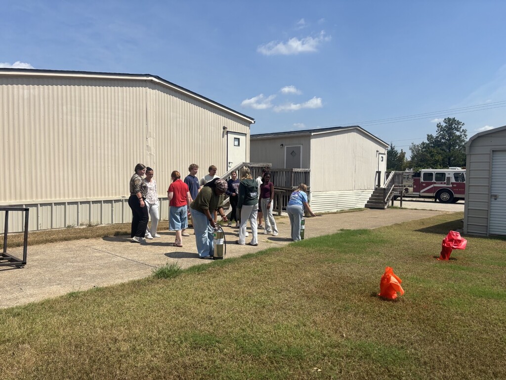 students practicing health care safety with fire extinguisher