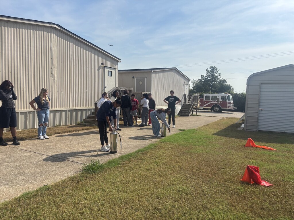 students practicing health care safety with fire extinguisher