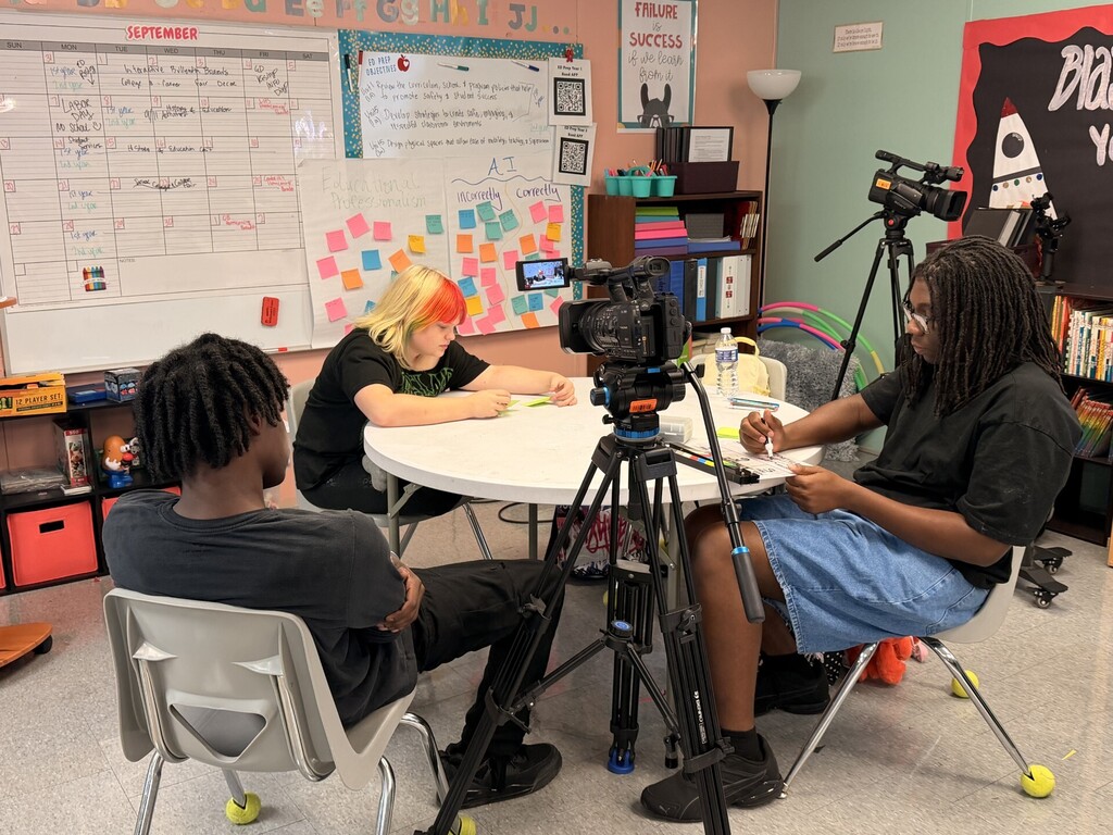 students taking notes and video