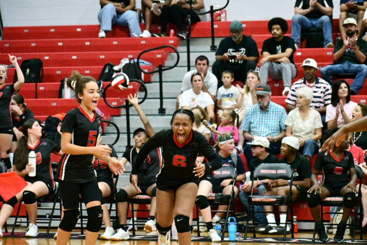 volleyball player running and screaming full of joy.