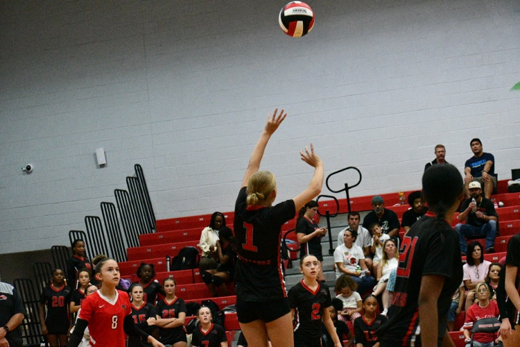 volleyball player jumping for the ball.