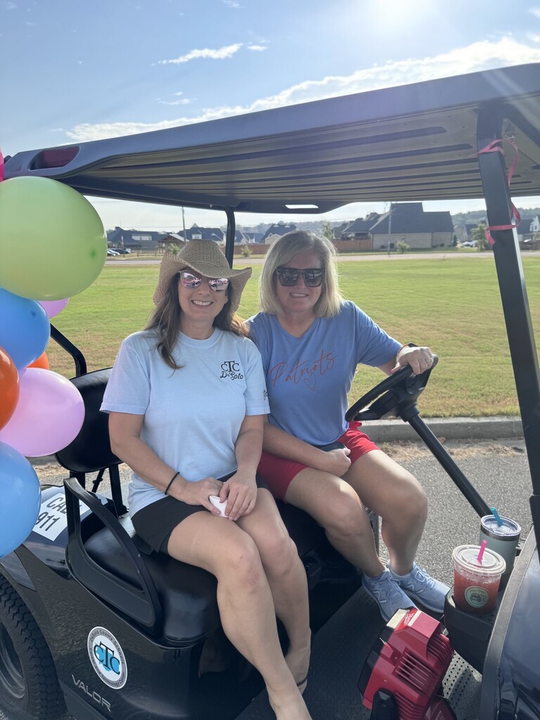 teachers on golf cart
