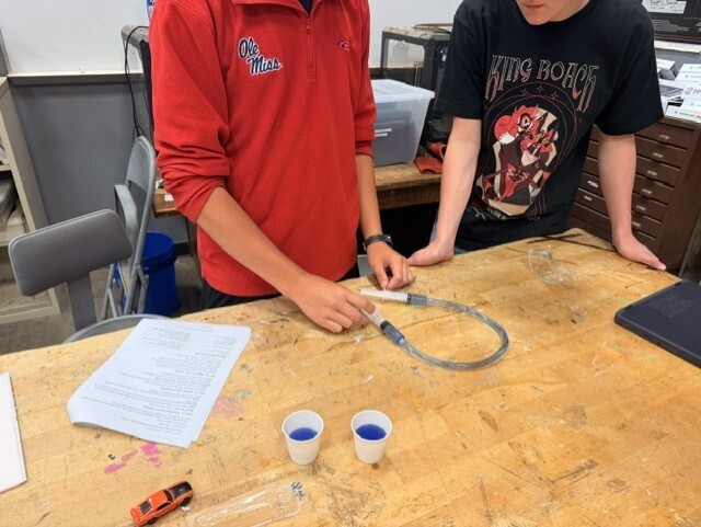 students creating hydraulic car lift