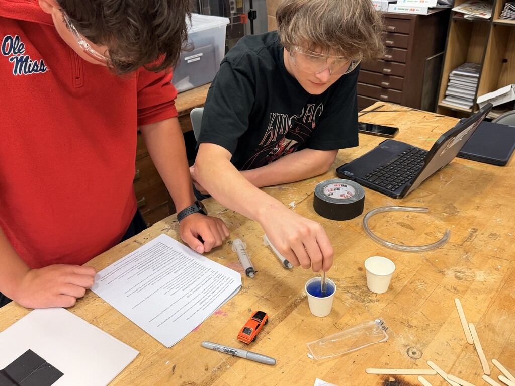 students creating hydraulic car lift