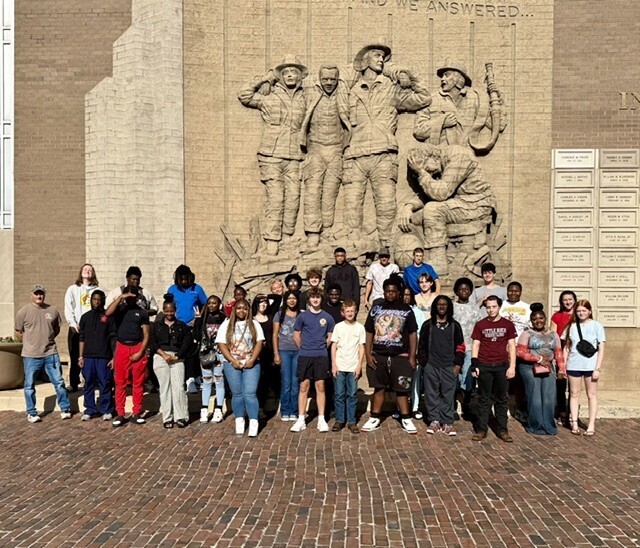 students posing before fire museum