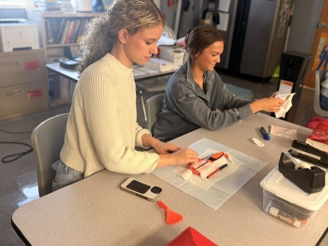 two students practicing sterile wrapping