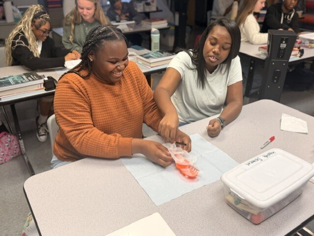 two students practicing sterile wrapping
