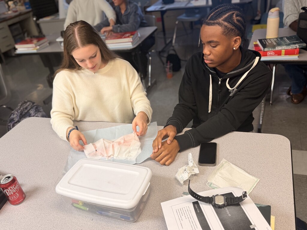 two students practicing sterile wrapping