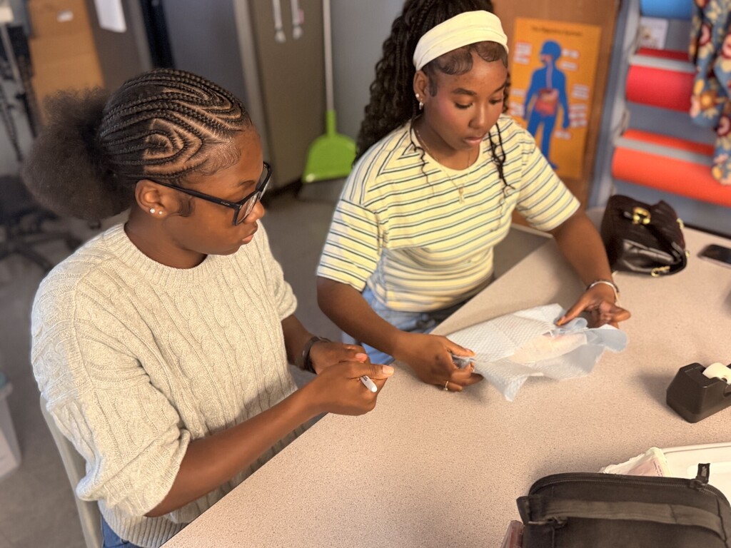 two students practicing sterile wrapping