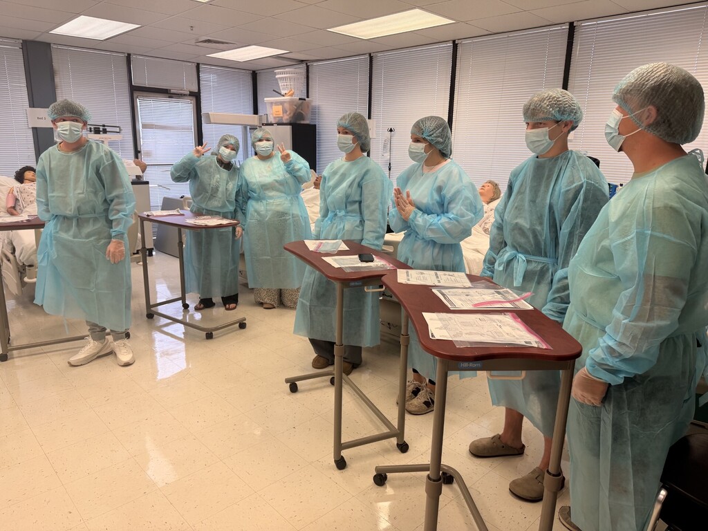 teacher and students in lab learning to put on protective 