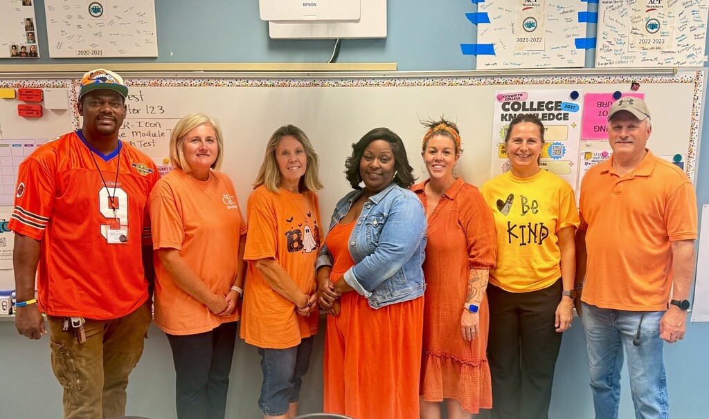 staff photo wearing orange