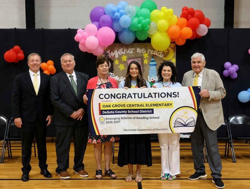 Board Members pictured with banner