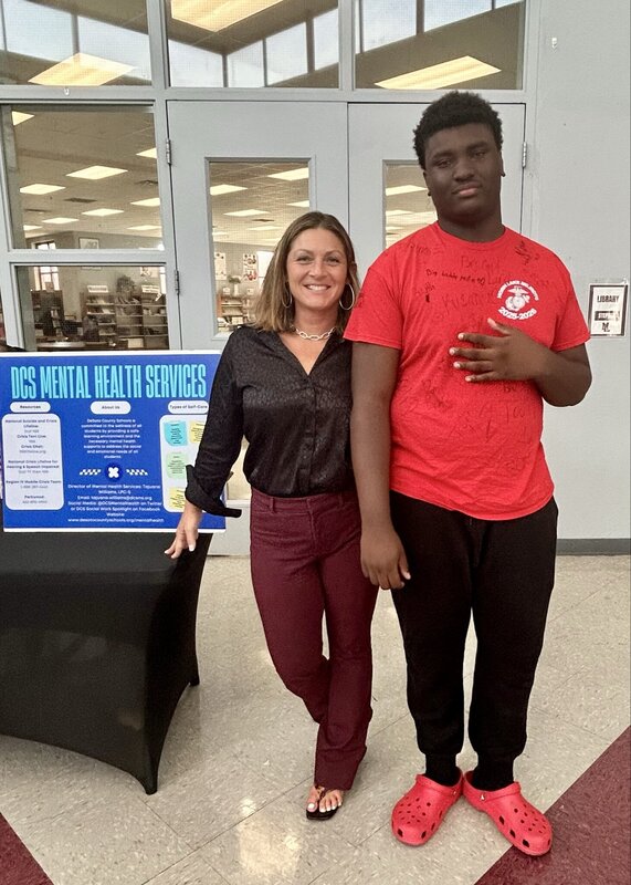 Ms. Leach poses with a student