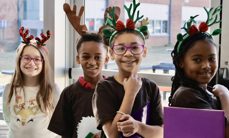 Students with reindeer ears smiling