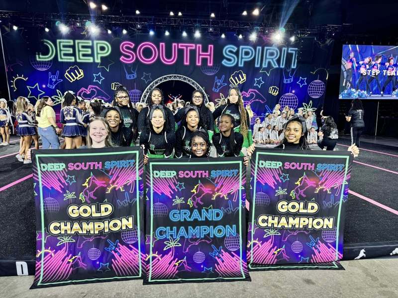 Dance and Cheer smiling with banners