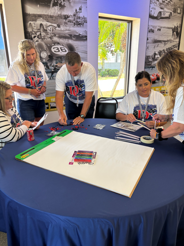 group of people around a table working on legos