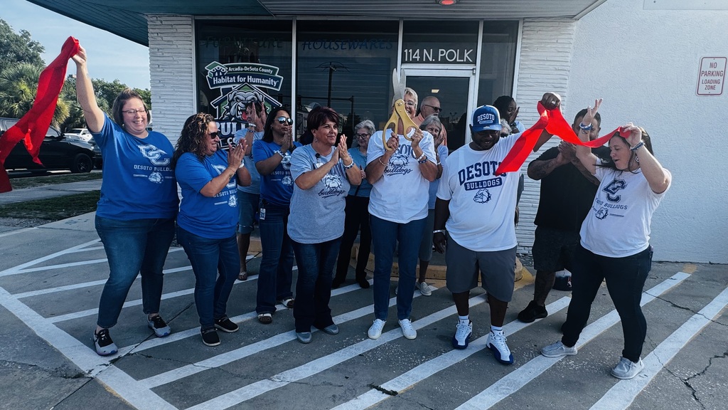 Habitat for Humanity staff posing for a photo, clapping hands and cheering