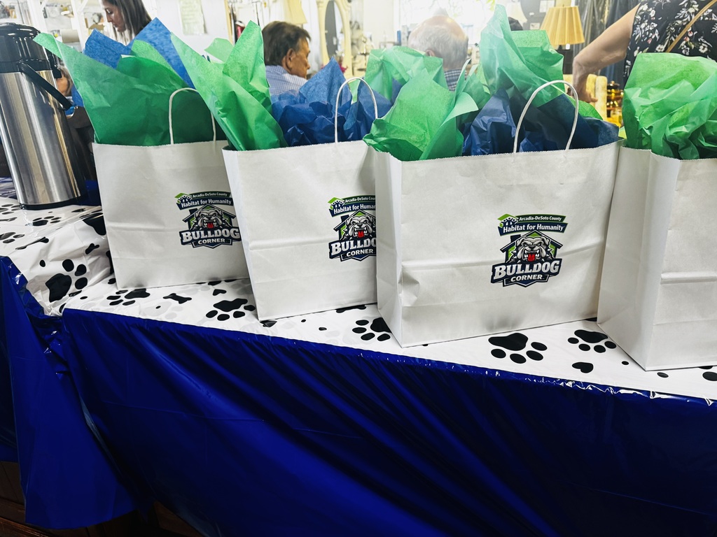 white gift bags with green and blue tissue paper