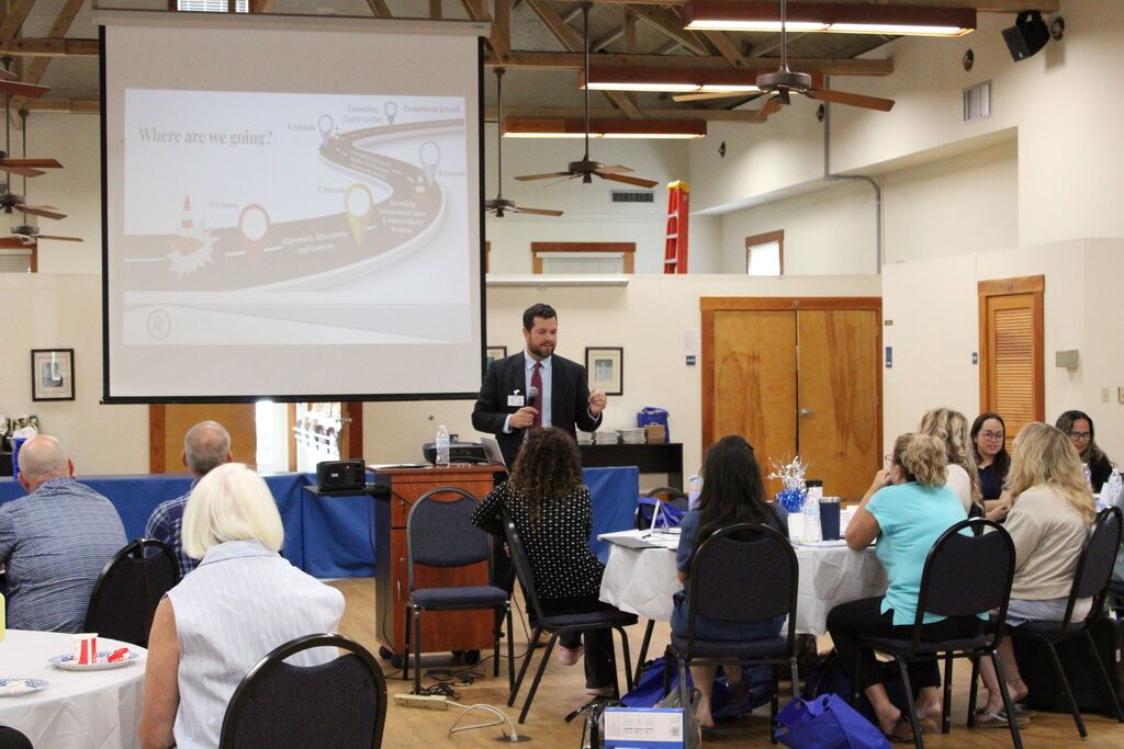 photo of man presenting to a group of educators