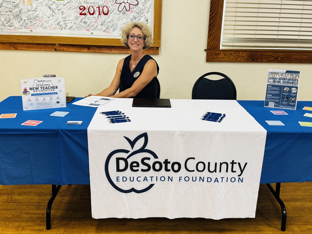 lady sitting a table with DeSoto County Education Foundation logo
