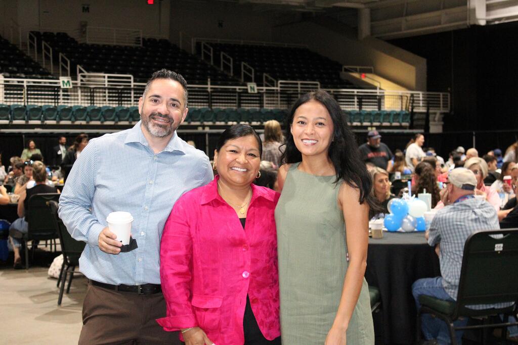 two women and one man smiling for a photo